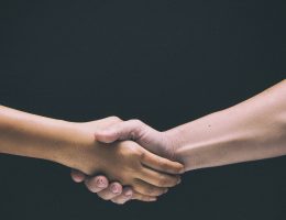 The abstract art design background of human hands touch together,check hand,sign and symbol of greeting and success deal ,vintage and art tone,classic old film style,blurry light around.